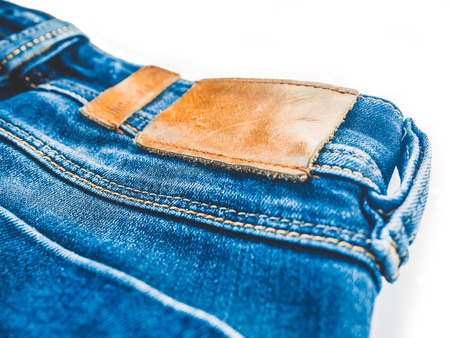 Denim background. Blue jeans with a brown leather label empty spaceの写真素材