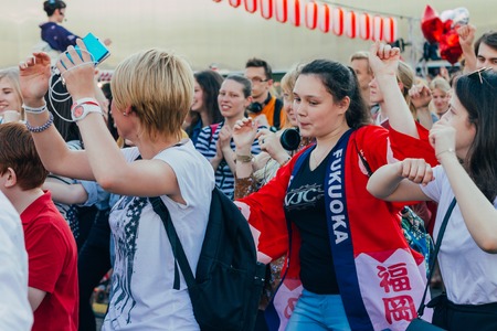 Moscow, Russia - April 24, 2016: People dancing around the stage of the Yagura the dance of Bon Odori at the japanese festival.のeditorial素材