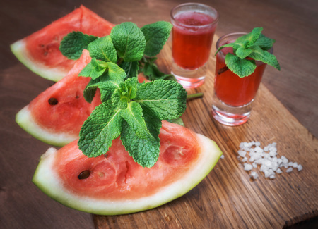 watermelon and watermelon pieces in a wooden background.の写真素材