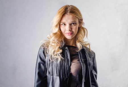 Young woman in a black leather rocker jacket.の写真素材