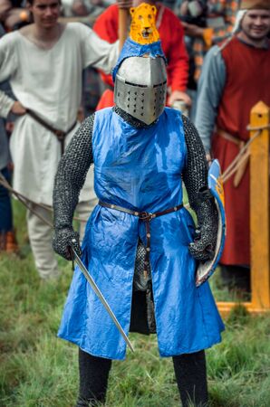RITTER WEG, MOROZOVO, APRIL 2017: Festival of the European Middle Ages. Portrait of medieval knight in helmet and chain mail battle on swords with shield in their hand.のeditorial素材