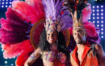 MOSCOW, RUSSIA- JANUARY 2017: Brazilian carnival show. Beautiful girl and boy bright colorful carnival costume on stage. Smiling afro-americans woman and man samba dancer couple on dance floorのeditorial素材