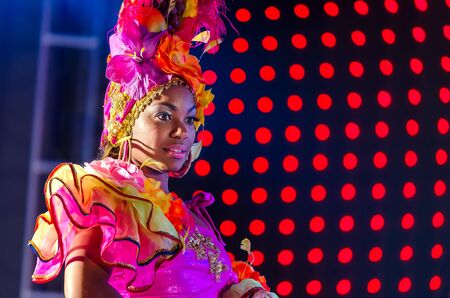 MOSCOW, RUSSIA- MAY 2017: Photo event with Beautiful girl bright carnival costume stage background. Portrait of cute latina woman samba dancer pink carnival costume dance floorのeditorial素材