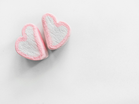 Two hearts marshmallows closeup, Pink marshmallow close up background, Sweets in the form of hearts...