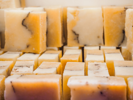 Bars of soap on a shop window. Orange soap with natural cedar oil and herbal ingredients. Handmade...