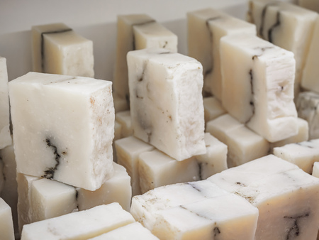 Bars of soap on a shop window. Pure natural soap with cedar oil and herbal ingredients. Handmade natural cold process soap. Eco-friendly exfoliating soap for hair and bodyの写真素材