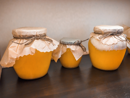 jars of candied lime honey on the shelf in shop. Sale of natural honey in market. Production of honeyの写真素材