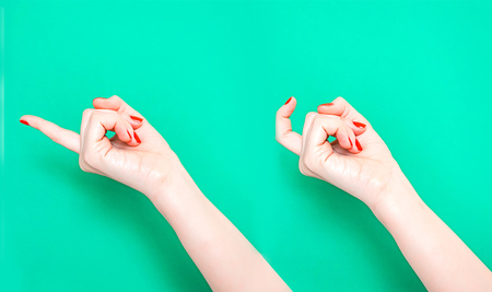 The Come Hither Hand Sign. Woman hand beckoning on isolated turquoise green color background. Female hand beckoning isolated on white background. Woman gesturing with one finger, come here symbol.の写真素材