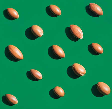 Argan nuts laid out on green background. Natural lighting in direct sunlight. A high resolutionの写真素材