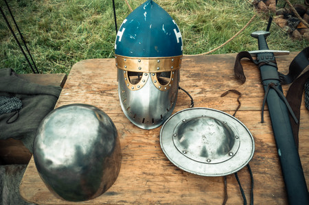 Medieval scene. Medieval knight attributes are helmet, chain mail, shield buckler, sword, halberd....