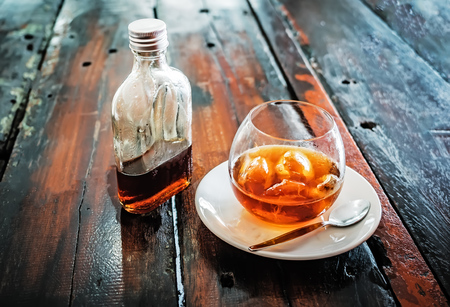A bottle of cold brew coffee and and ice in glass with prepared Cold Brew drink