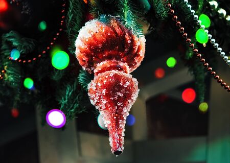 Red icicle with pieces of ice christmas tree decoration hanging on stret season fair. Christmas lights. Christmas decorations, Christmas tree toys - New Year holiday backgroundの写真素材