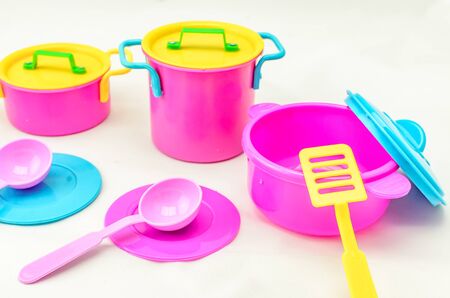 Set of childrens toy colorful dishes isolated on white background. Kid toy utensil for girls gameの写真素材