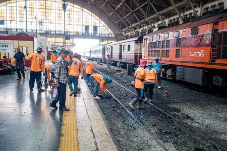 Bangkok, Thailand - May 25, 2019: Repair works on the Hua Lamphong railway station. Laying of new railway rails on a city. Railway repair. Installation of new modern railway rails. Installing the latches on railway sleepers. Reconstruction of railwayのeditorial素材