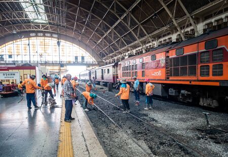 Bangkok, Thailand - May 25, 2019: Repair works on the Hua Lamphong railway station. Laying of new railway rails on a city. Railway repair. Installation of new modern railway rails. Installing the latches on railway sleepers. Reconstruction of railwayのeditorial素材