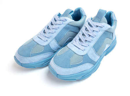 Light blue sneakers on a white background. Sports shoesの写真素材