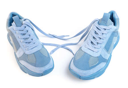 Light blue sneakers on a white background. Sports shoesの写真素材