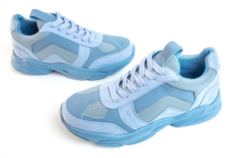 Light blue sneakers on a white background. Sports shoesの写真素材