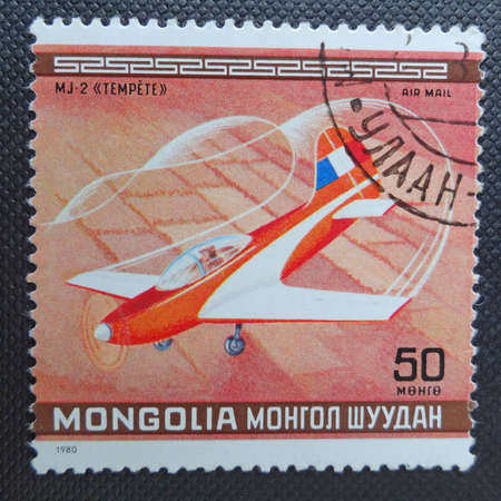 MONGOLIA - CIRCA 1980: A stamp printed in MONGOLIA commemorates World Acrobatic Championship in Oshkosh in Wisconsin and it shows a French sports aircraft Jurca MJ-2 Tempete, circa 1980.のeditorial素材