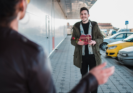 Man gives present to her girlfriend at woman's day.の写真素材