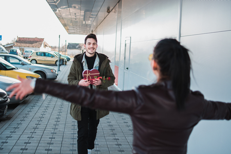Man gives present to her girlfriend at woman's day.の写真素材