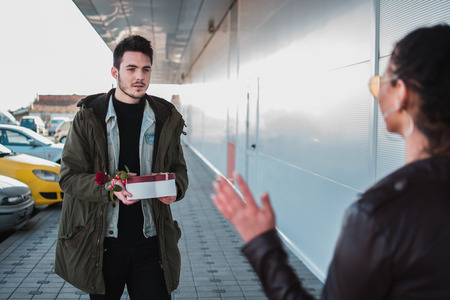 Man gives present to her girlfriend at woman's day.の写真素材