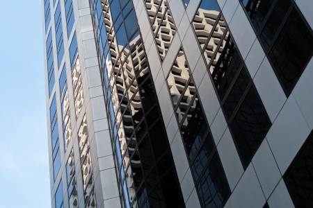 HONG KONG - SEPTEMBER 18: Building reflection in glass panels of another building on September 18, 2011 in Hong Kong. HK features great emphasis on Contemporary architecture - Modernism and Functionalism.のeditorial素材
