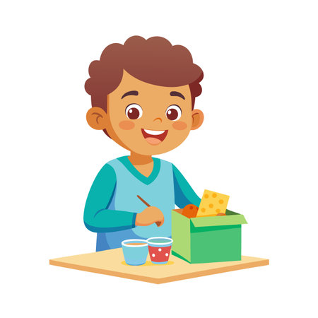 Happy boy crafting with paper and glue at the table with a cheerful smileのイラスト素材