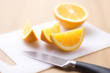 Sliced orange on wooden background - horizontal imageの写真素材
