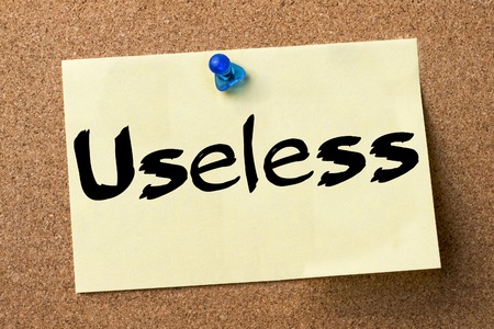 Useless - adhesive label pinned on bulletin board - horizontal imageの写真素材