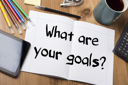 What are your goals? - Note Pad With Text On Wooden Table - with office  toolsの写真素材