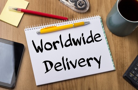 Worldwide Delivery - Note Pad With Text On Wooden Table - with office  toolsの写真素材