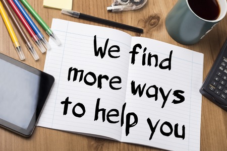 We find more ways to help you - Note Pad With Text On Wooden Table - with office  toolsの写真素材