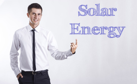 Solar energy - Young smiling businessman pointing on text - horizontal imagesの写真素材