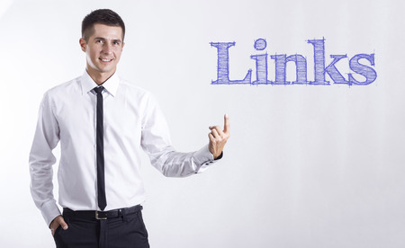 Links - Young smiling businessman pointing on text - horizontal imagesの写真素材