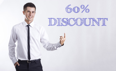 60% DISCOUNT - Young smiling businessman pointing on text - horizontal imagesの写真素材