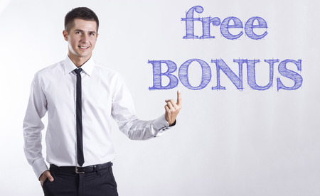 Free BONUS - Young smiling businessman pointing on text - horizontal imagesの写真素材