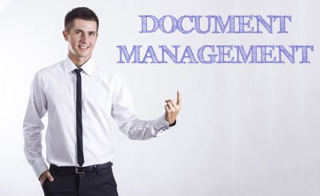 DOCUMENT MANAGEMENT - Young smiling businessman pointing on text - horizontal imagesの写真素材