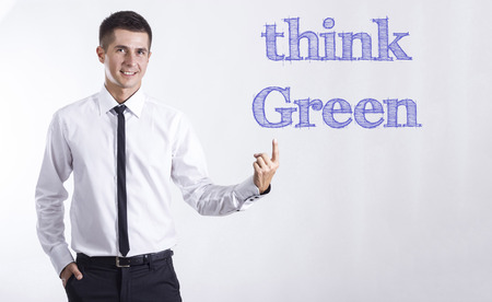 Think Green! - Young smiling businessman pointing on text - horizontal imagesの写真素材