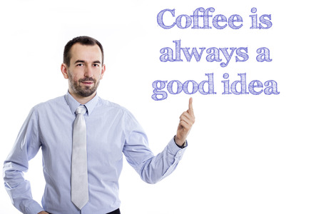 Coffee is always a good idea - Young businessman with small beard pointing up in blue shirt - horizontal imageの写真素材