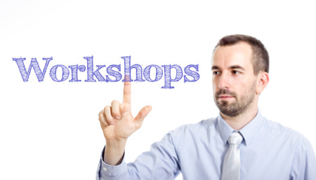 Workshops Young businessman with small beard touching text - horizontal imageの写真素材