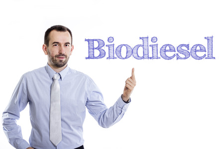 Biodiesel - Young businessman with small beard pointing up in blue shirt - horizontal imageの写真素材