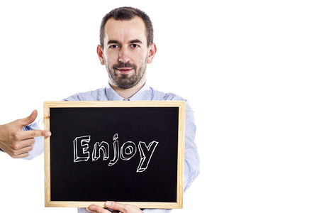 Enjoy - Young businessman with blackboard - isolated on white - horizontal imageの写真素材