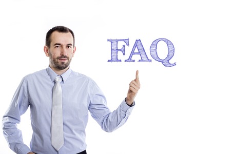 FAQ  Young businessman with small beard pointing up in blue shirt - horizontal imageの写真素材