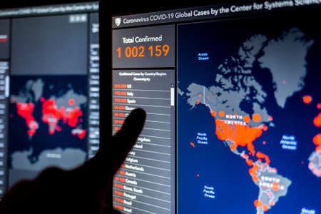 Over 1 million. Number of Total Confirmed Cases. Expert point Coronavirus COVID-19 global cases Map Johns Hopkins University map on monitor display.のeditorial素材