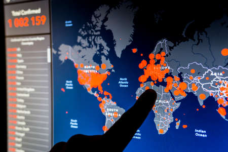 Over 1 million. Number of Total Confirmed Cases. Expert point Coronavirus COVID-19 global cases Map Johns Hopkins University map on monitor display.のeditorial素材