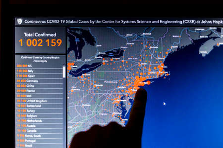 Over 1 million. Number of Total Confirmed Cases. Expert point Coronavirus COVID-19 global cases Map Johns Hopkins University map on monitor display.のeditorial素材