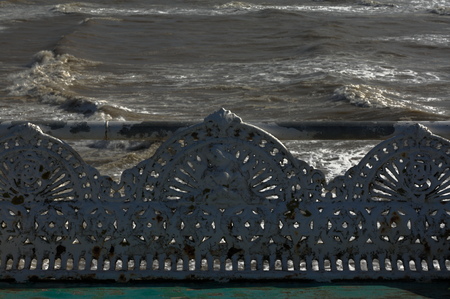 Cast iron park benches on a windy seashoreの写真素材