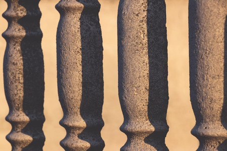 Concrete rhythmed fence with holes and shadows in perspectiveの写真素材