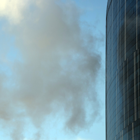 Big skyscraper Business Office among clouds in blue skyの写真素材